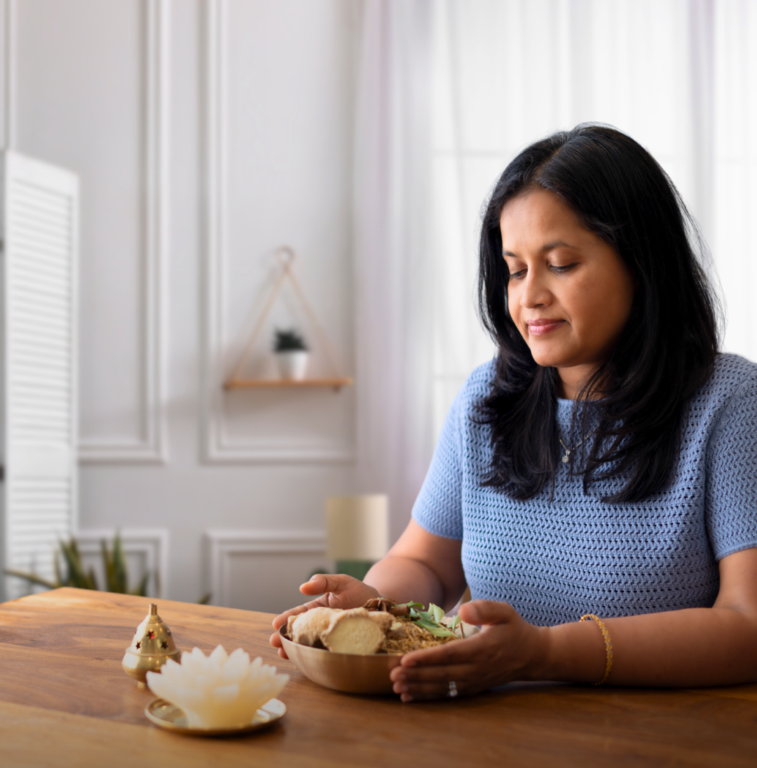 Viji seated at a table in a warm, welcoming space